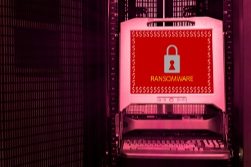 image of red computer with word ransomware across the computer's screen on red and black background